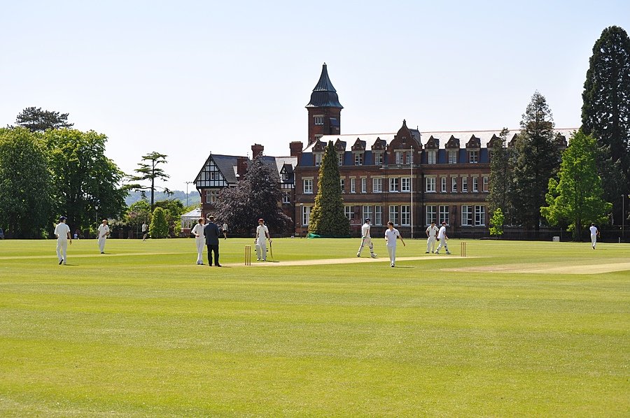 Dean Close School with students playing Cricket in the front