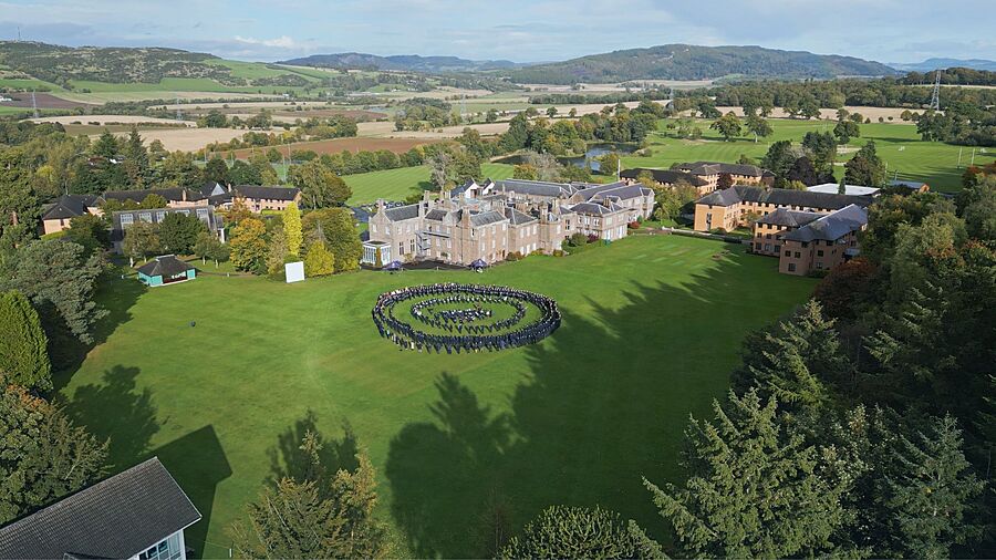 Areal view of Strathallan School and campus with students outside lined up in a big circular formation