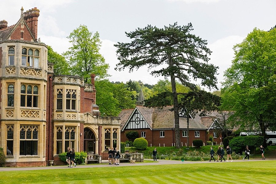 Red-brick manor house with Victorian stone cladding, tree to the right