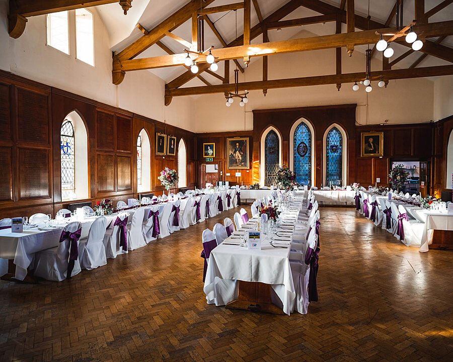 A big dining room with beautifully laid tables at King Williams College