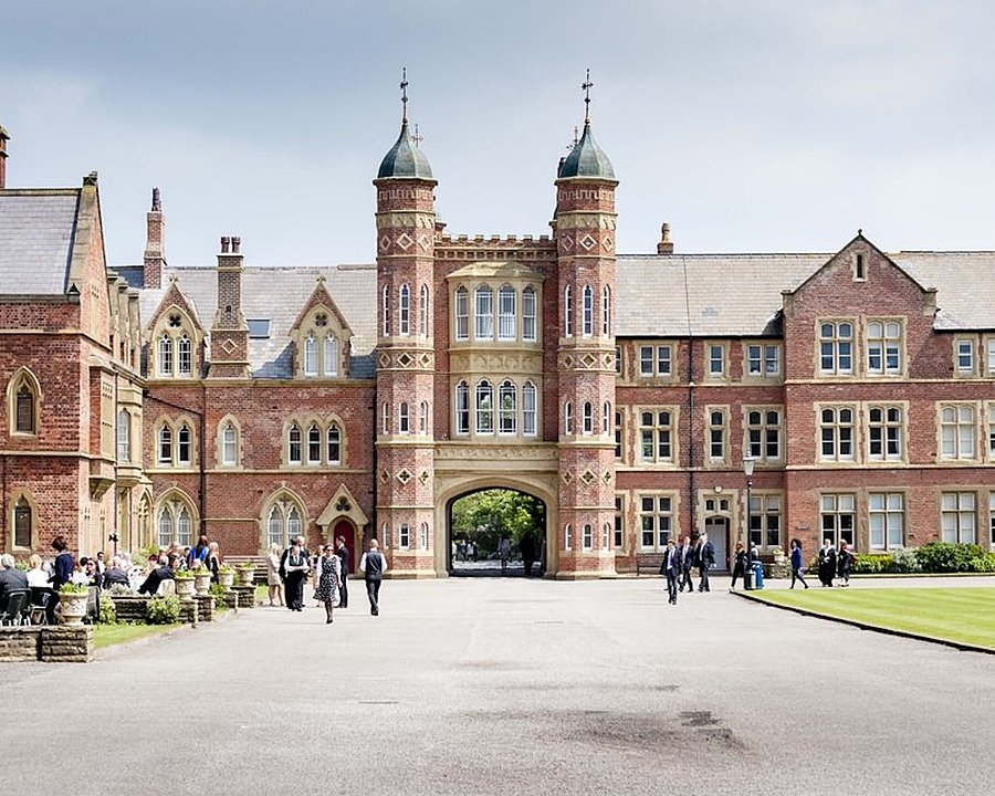 Students on the school campus with the stunning buildings of Rossall School behind