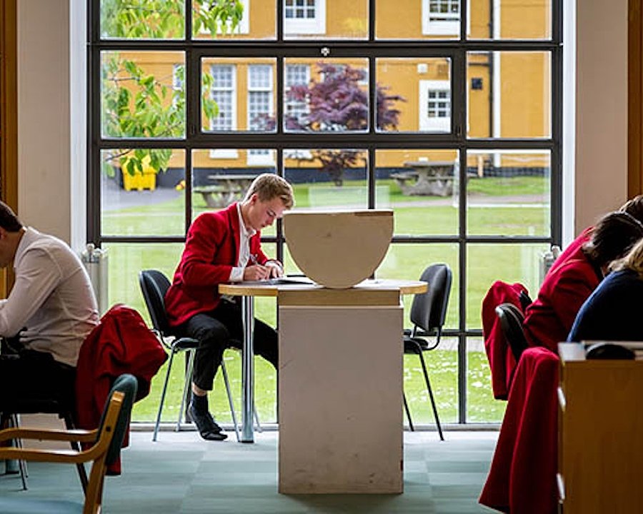 Loretto School students learning at tables in the school's library