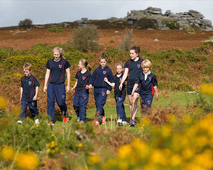 Six pupils of different ages hicking through Dartmoor