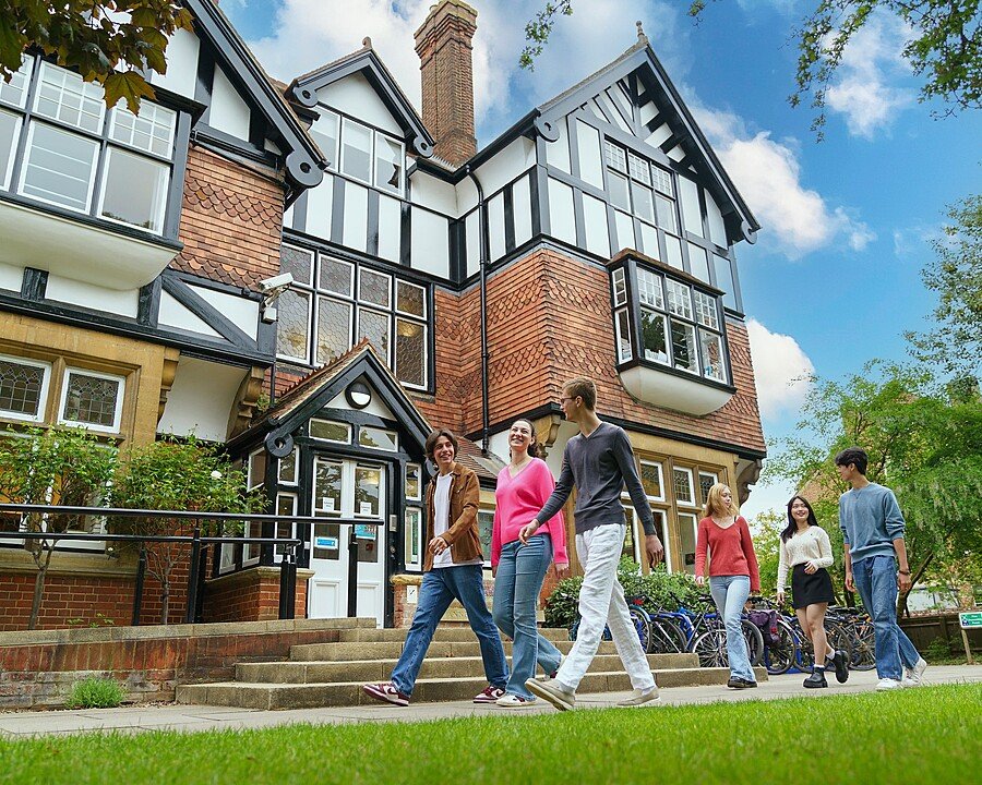 A group of Summer School students walking past the library on the campus