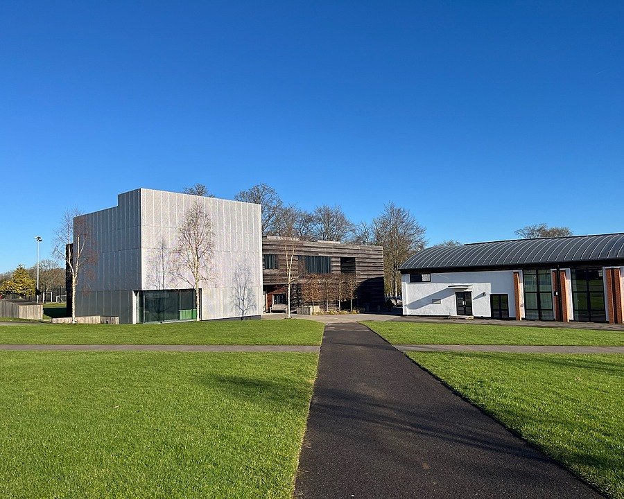 Modern school buildings with lawns and paths at Pangbourne College