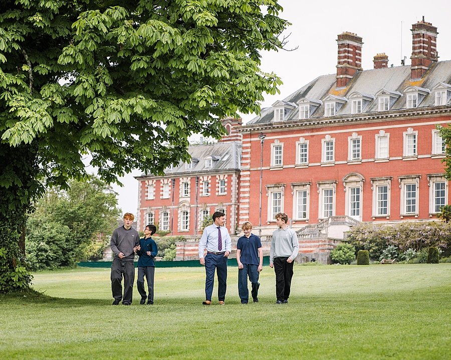 Students walking over the lawn of one the Boys Boarding houses at Bryanston School