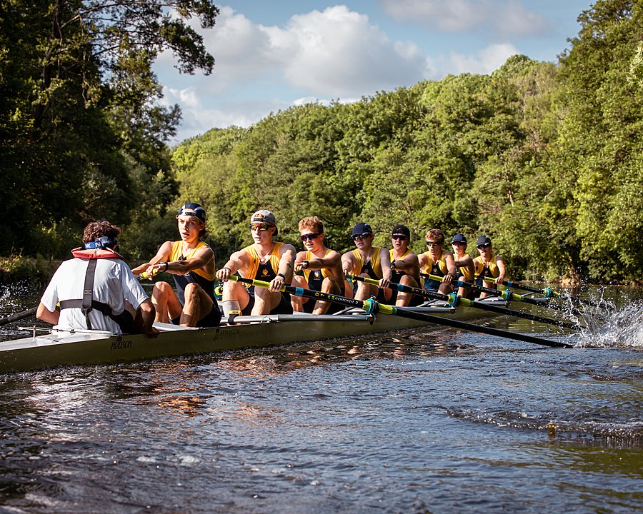 Eight students from Bryanston School in a rowing boat during their training