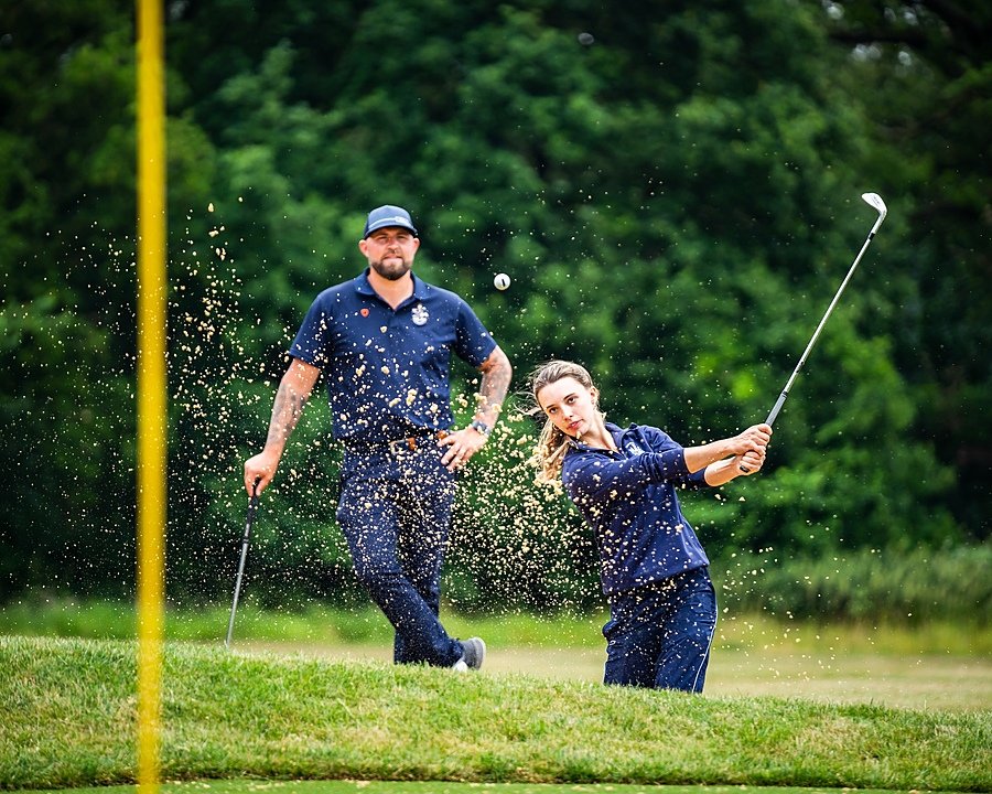 A student from Culford school during her golf training with her teacher on the golf course