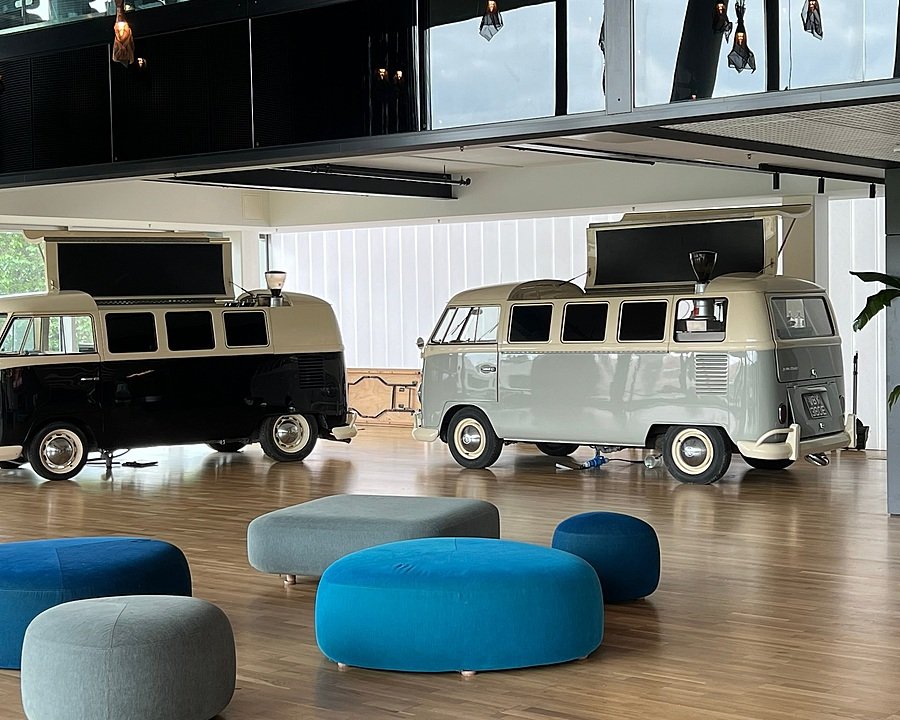two restored VW Camper vans on the Brighton College Campus
