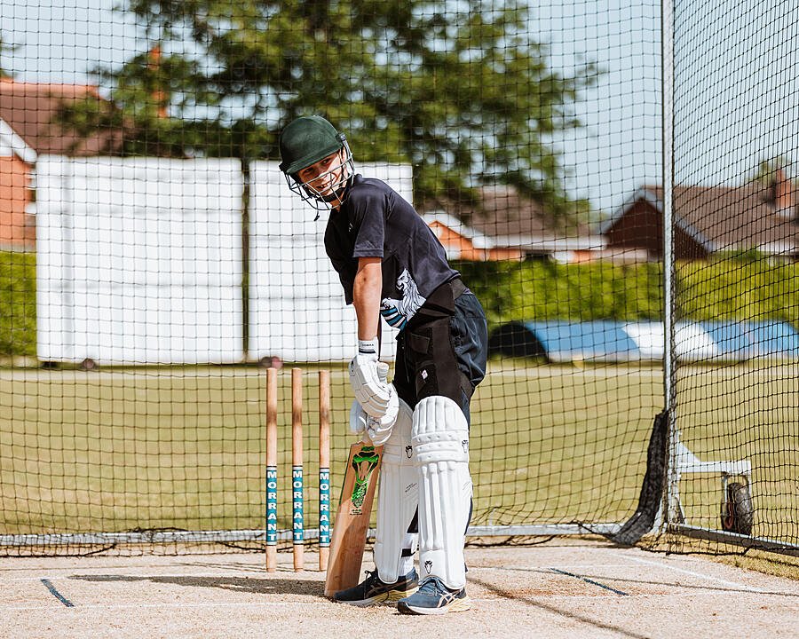 A student playing cricket at Wrekin College