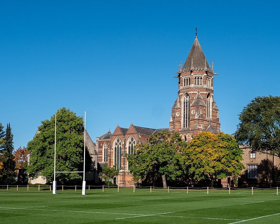 Rugby School with its impressive tower and a rugby pitch in the foreground