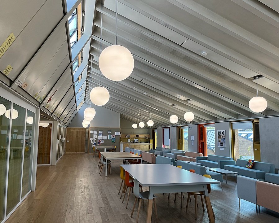 Tables with chairs and sofas with coffee tables in the attic of the school