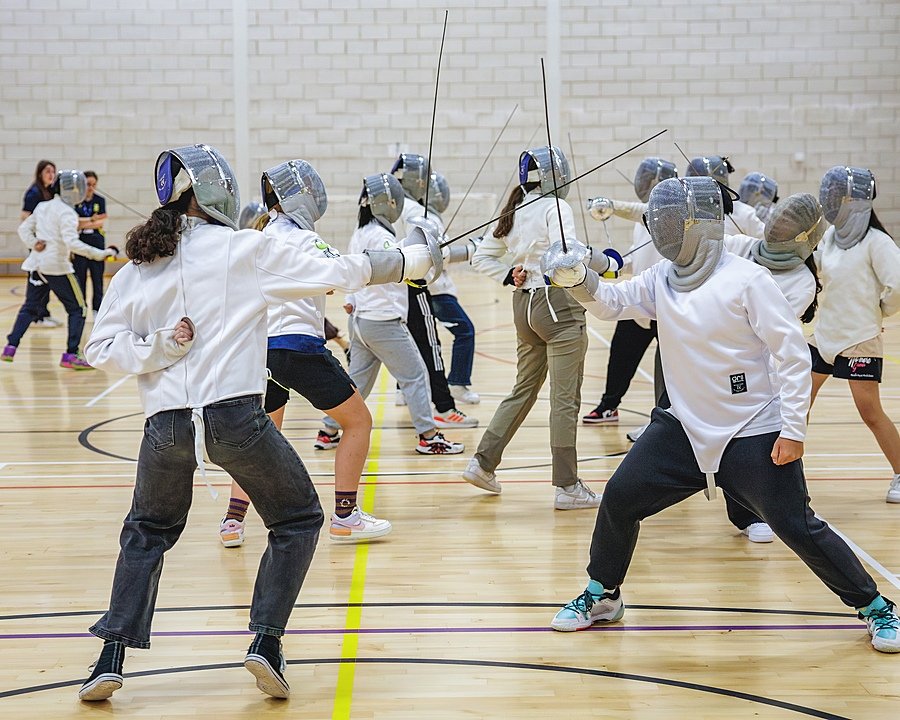 Students fencing in a sports hall during the Sedbergh International Summer School