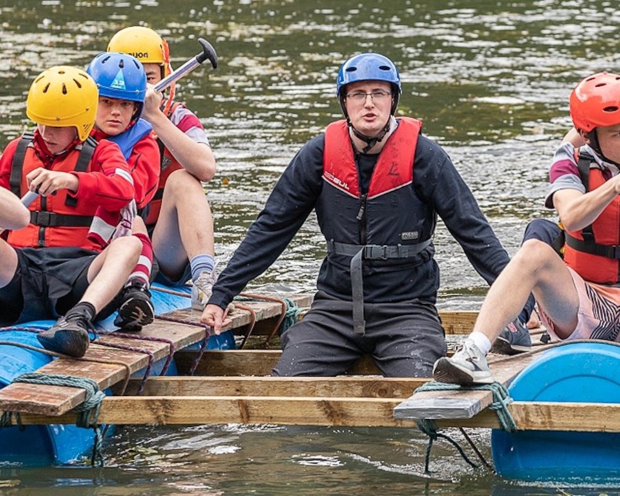 Children in self-made float paddling