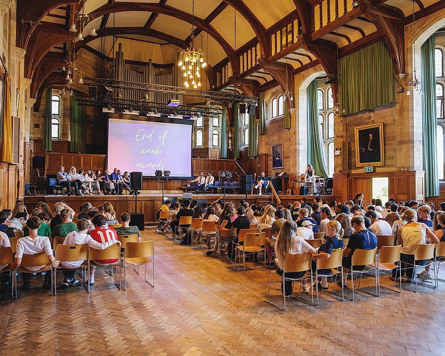 students in the assembly hall of Sedbergh's International Summer School End of week award