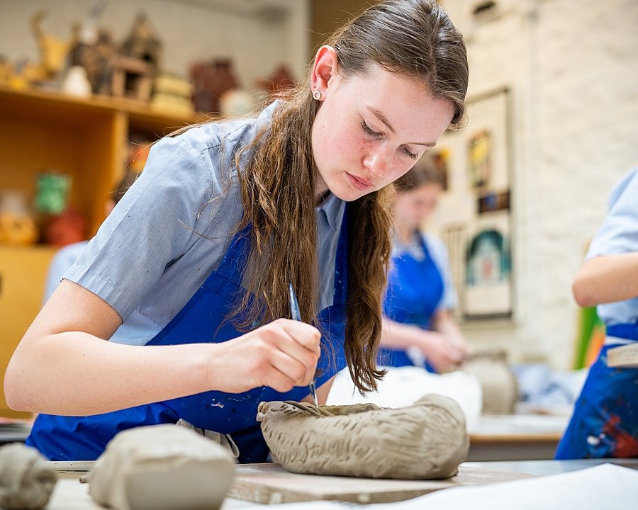 A girl doing a pottery project