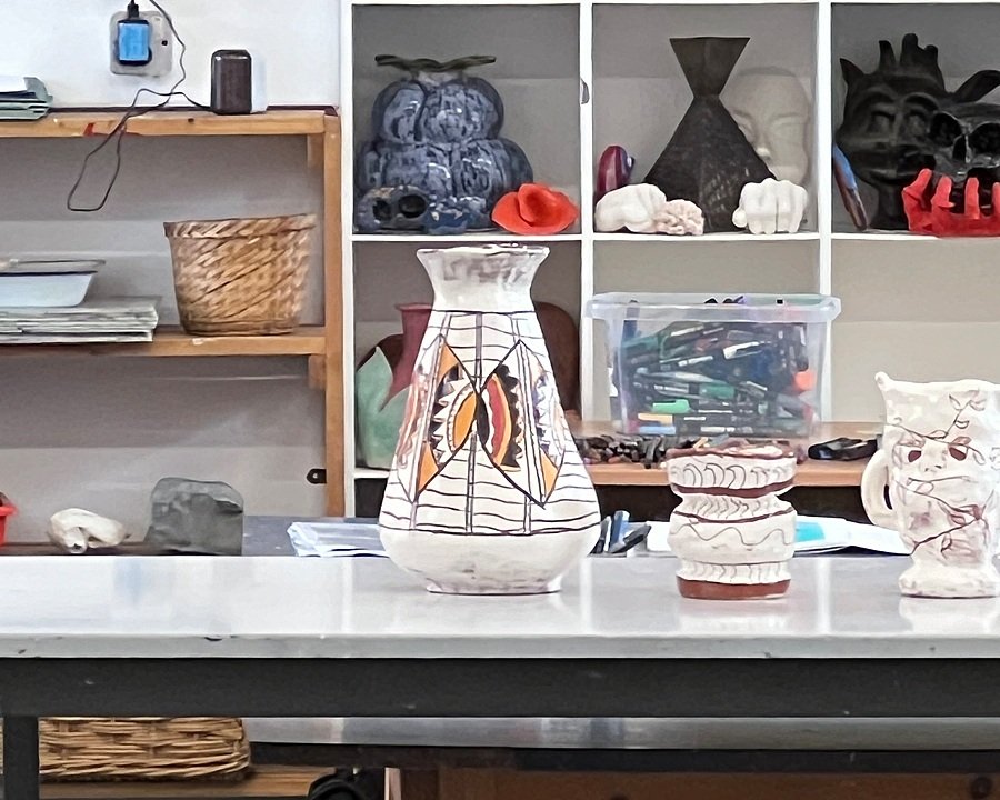 A table in an art department with vase on it