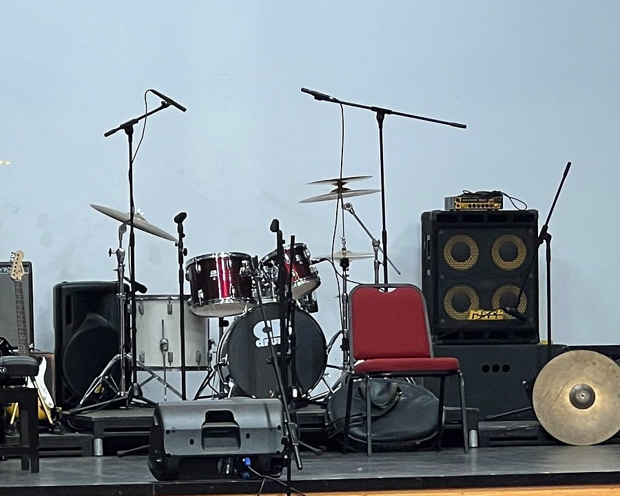 A drum kit and microphones on a stage