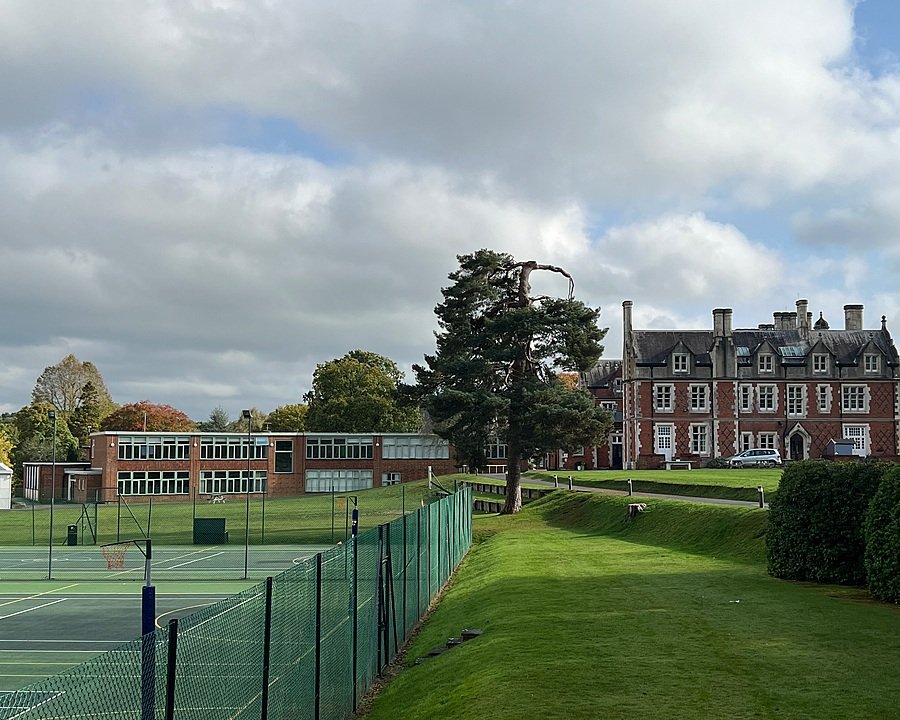 A school campus with outdoor tennis courts in cloudly weather