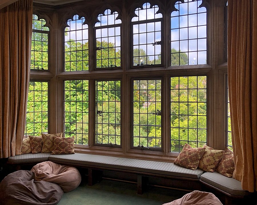 Old bay window with cushions for sitting and reading