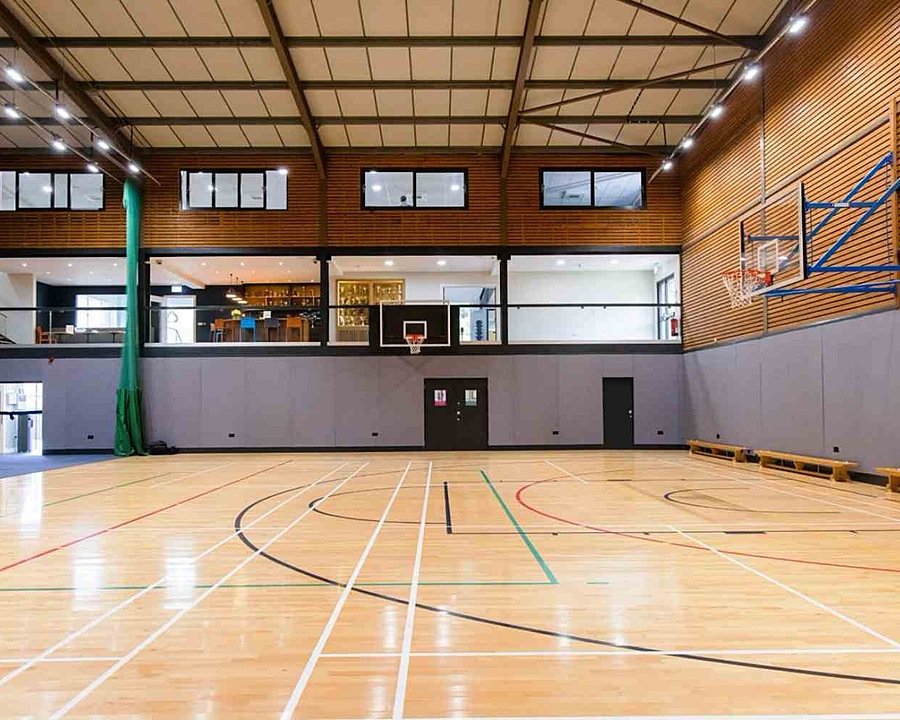 A well-lit sports hall with basketball hoops