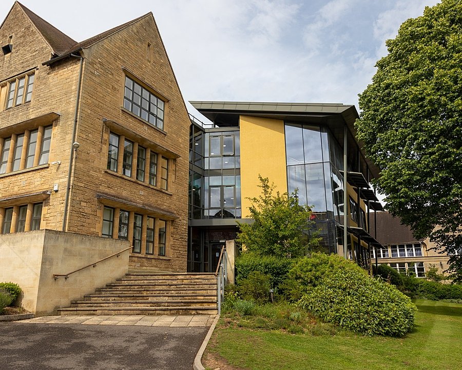 Contemporary academic building with glass façade and landscaped surroundings