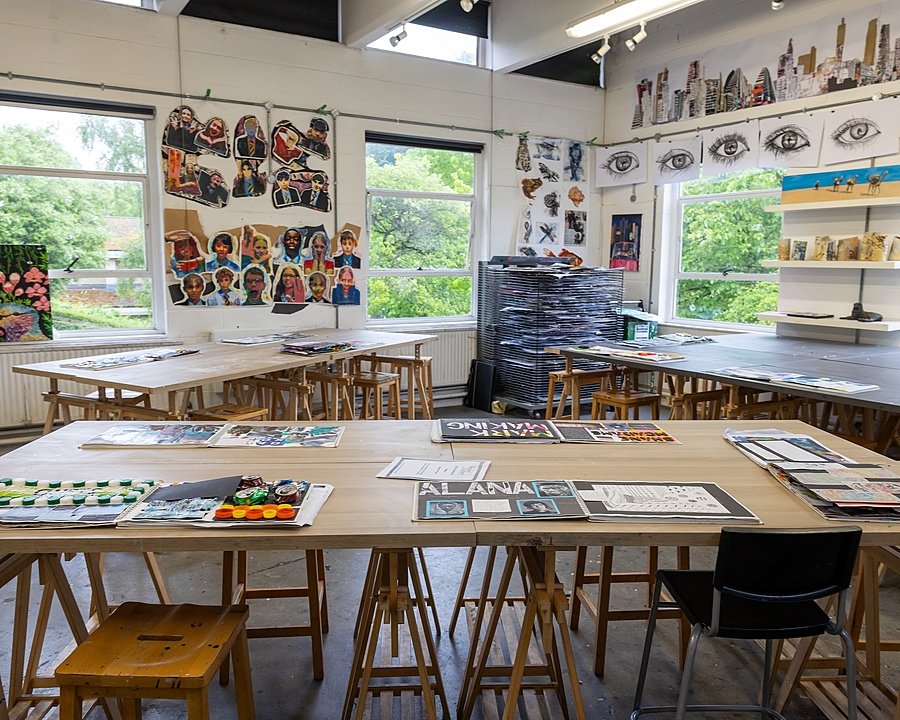Inside the art department with lots of drawings hanging on the walls
