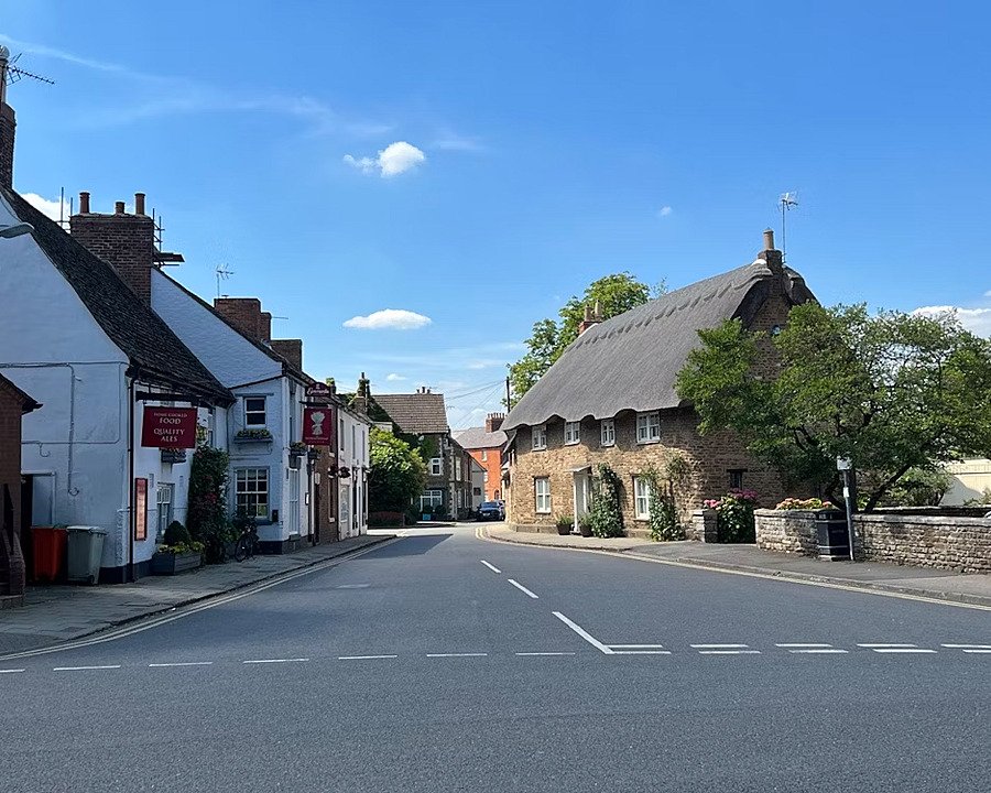 a village road with lovely old houses