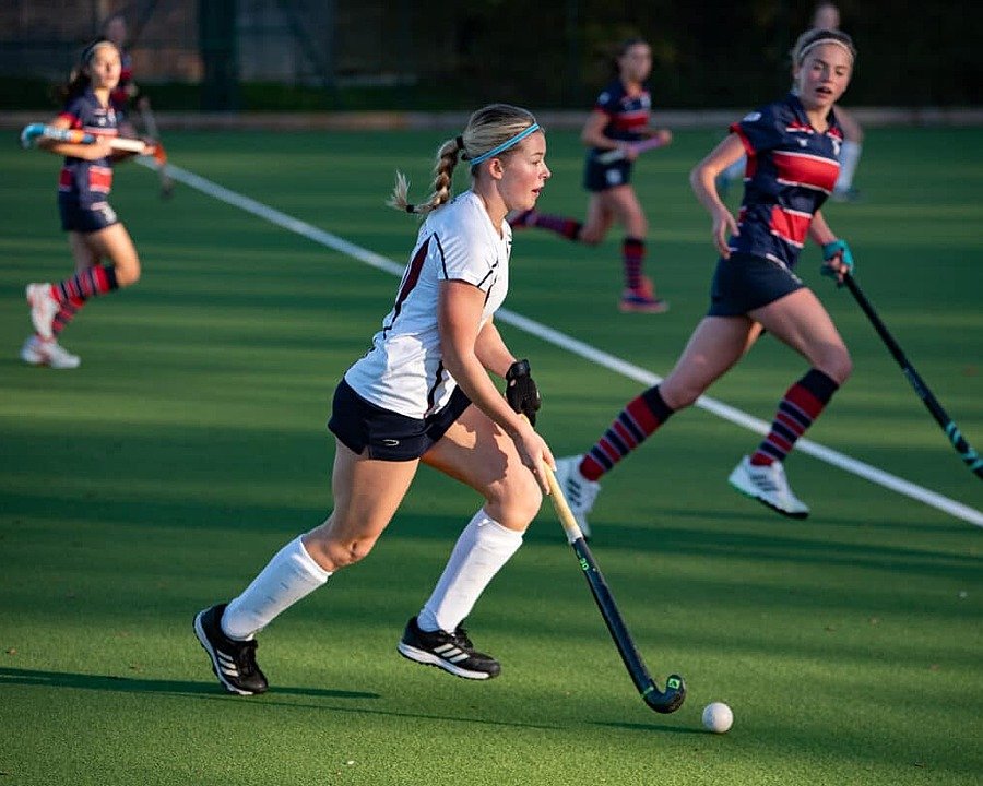girls Hockey players in action on the pitch