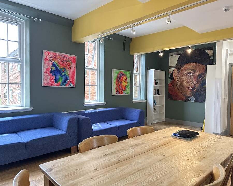 Spacious room with two blue sofas and a wooden table