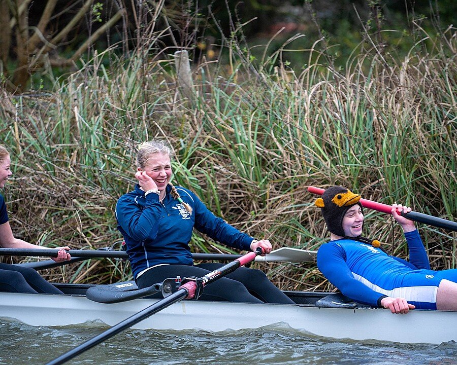Three Canford School students rowing and having fun