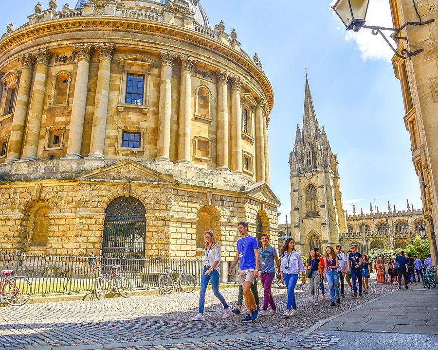 a group of visitors between the impressive buildings on a trip to Oxford