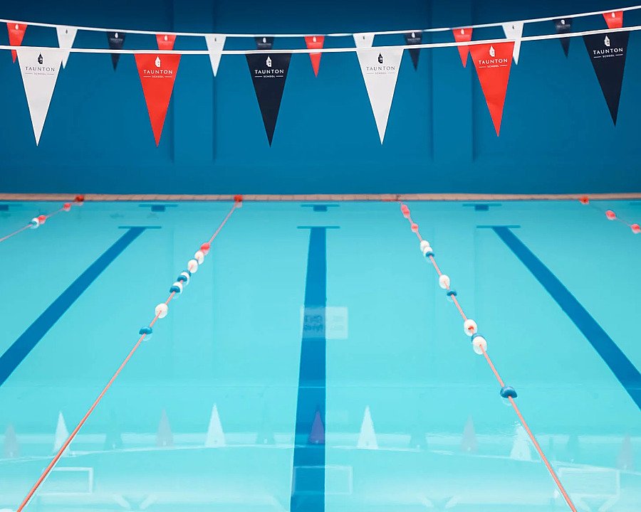 The indoor swimming pool at Taunton School with buntings in red, white and black