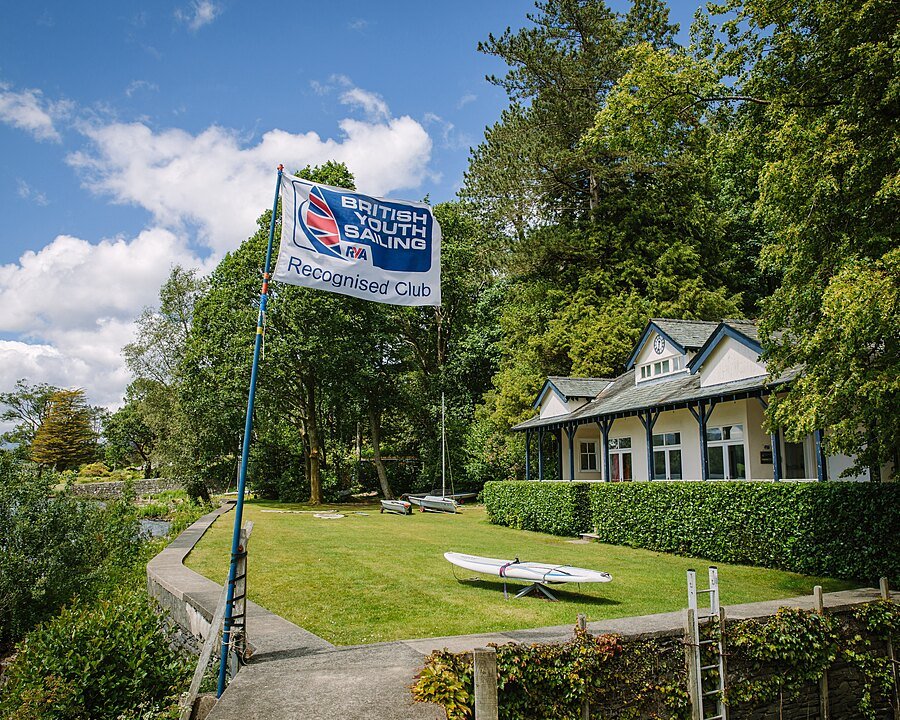 RYA British Youth Sailing Recognised Club flag outside a school building.
