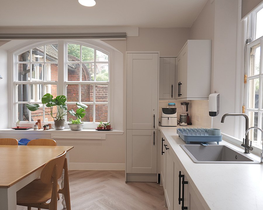 A bright, modern kitchen with a table and sink