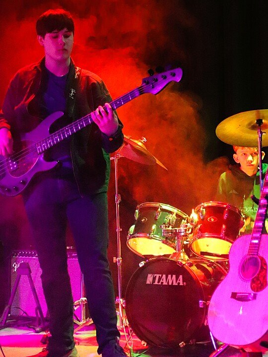 Student band performing on stage during a school music event.