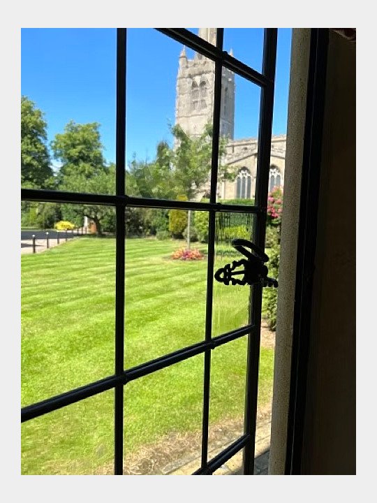 Sunny view from a window at Oakham School onto the green campus