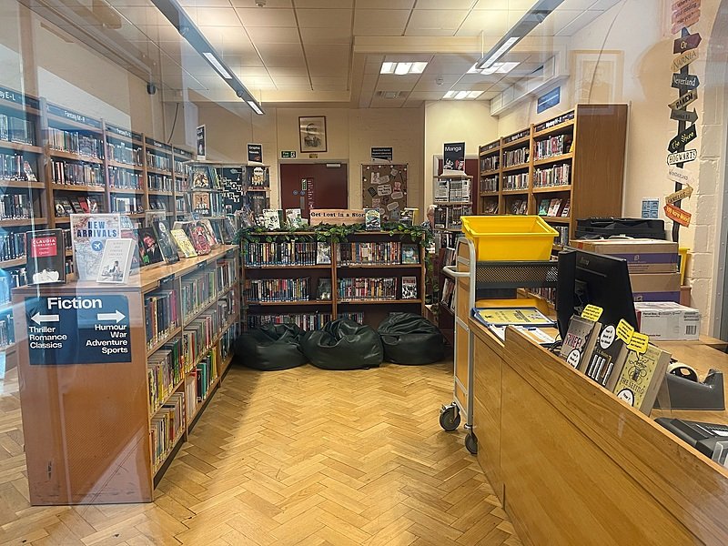 School library with bookshelves and bean bags at British boarding school