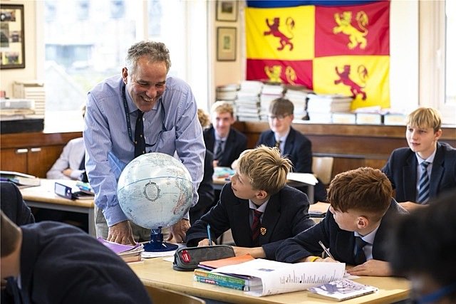 Geography teacher in friendly conversation with pupils at Barnard Castle