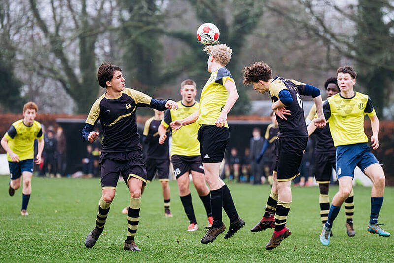 Charterhouse students playing football and heading the ball