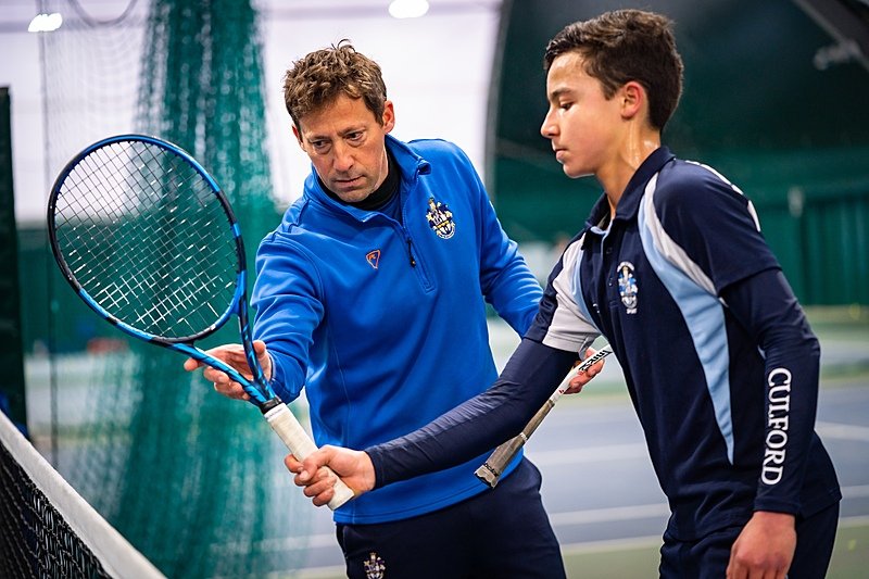 A Culford School student during his indoor tennis lesson with his tennis coach