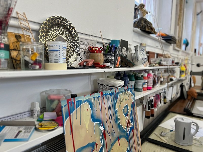 Shelves full of art and craft utensils in the school's bright art department