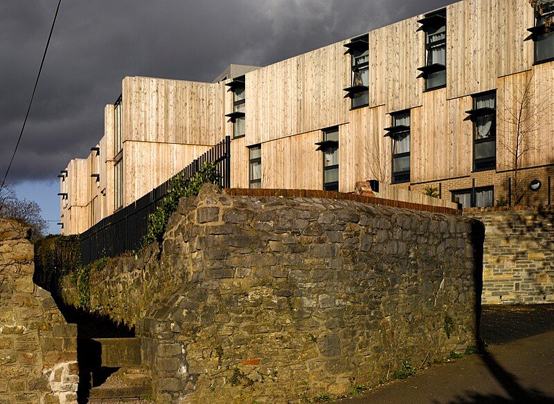 Modern building with wood cladding and open windows