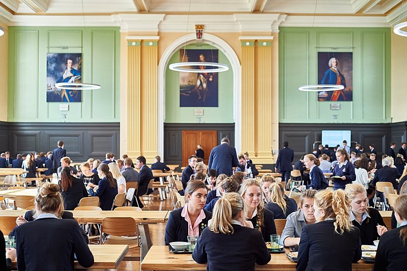 dining hall at Royal Hospital School with long wooden benches and tables