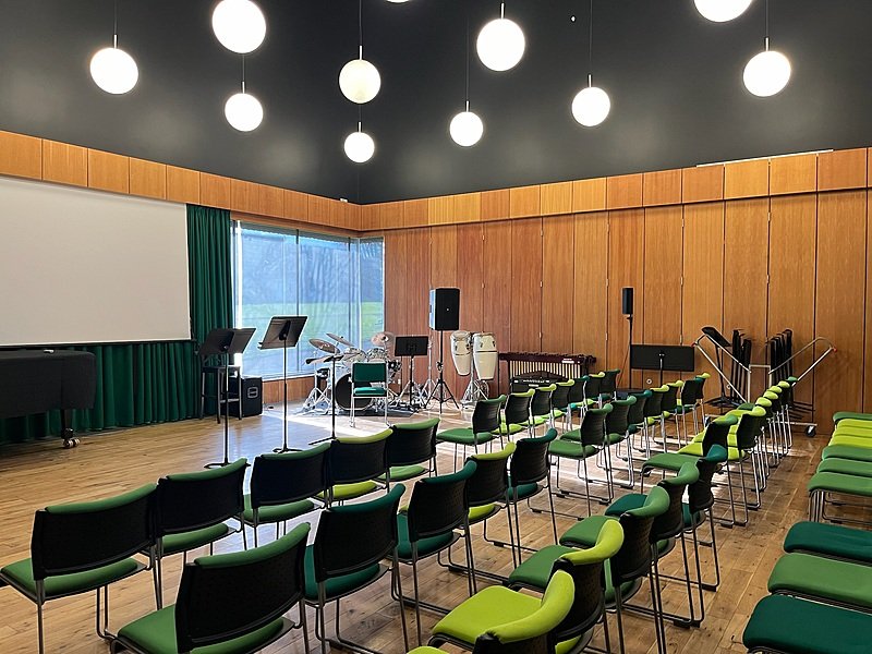 Music room with chairs, stands and instruments at Pangbourne College