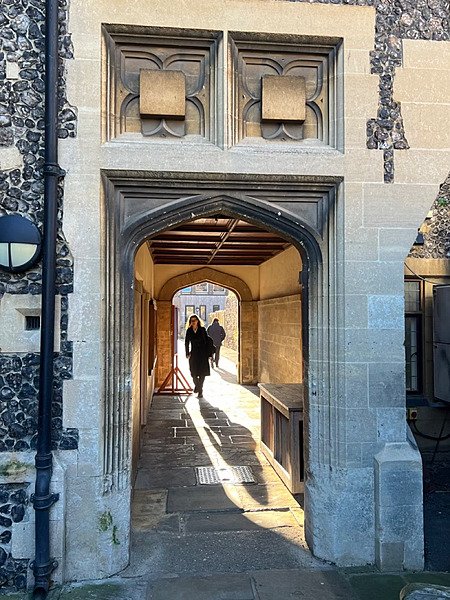 a beautiful sun flooded stone archway at King's School Canterbury