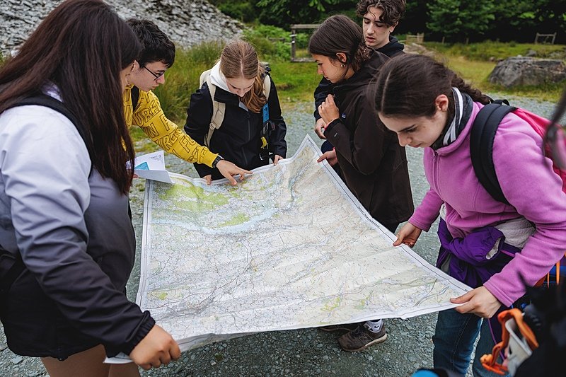 Students looking together at a map during a Sedbergh International Summer School outdoor Challenge