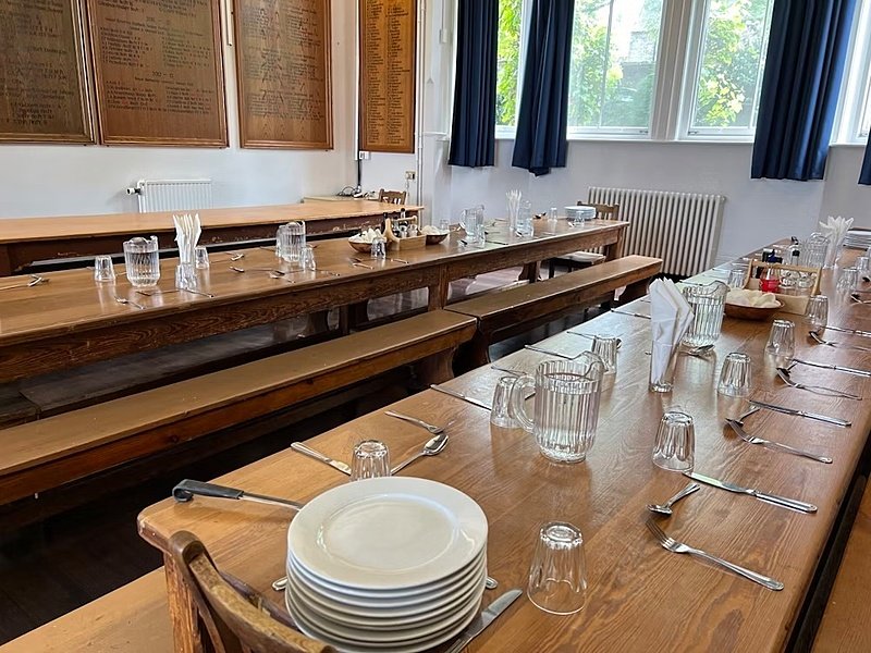 Long set dining tables for the in house dining at the boarding houses