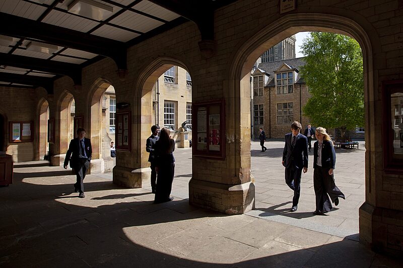 Stone archway on the school ground flooded by sunlight