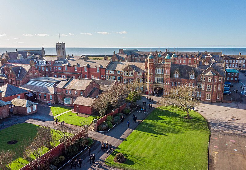 an areal view of the Rossall School and campus with the sea in the background